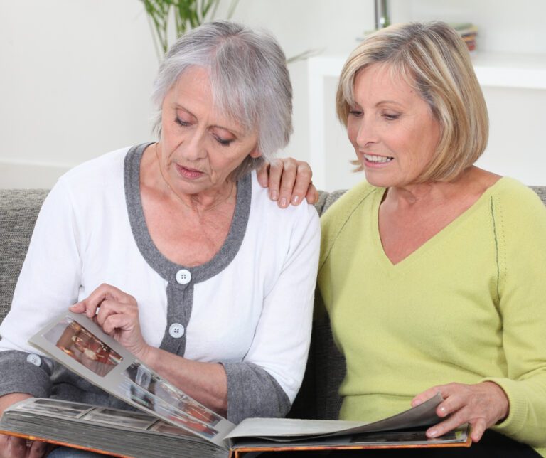 The Heritage of Green Hills | Senior woman and caregiver reading together