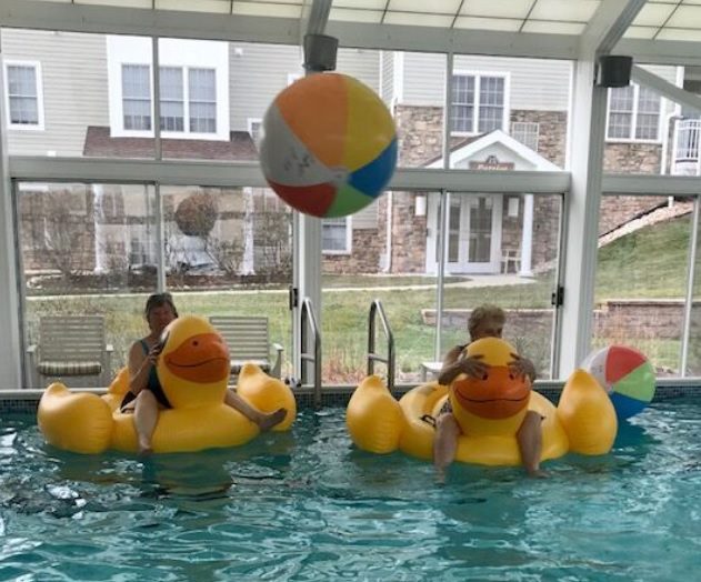 The Heritage of Green Hills | Seniors sitting on rubber duck pool inflatables